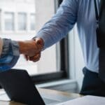 man shaking hand with corporate partner for charity