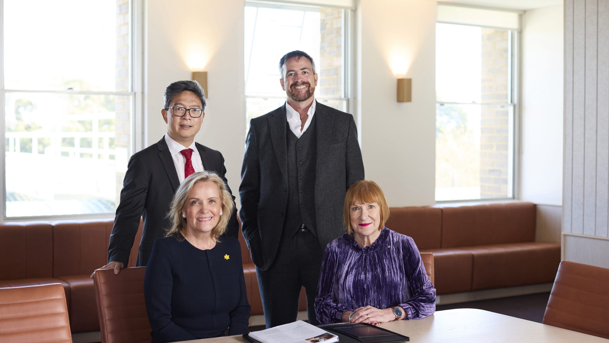 In this photo, we have Professor Elgene Lim, Cancer theme lead at UNSW Medicine & Health, and UNSW Vice-Chancellor and President Professor Attila Brungs in the back row, and Cancer Council NSW CEO Professor Sarah Hosking and cancer survivor Ainslie Cahill AM in the front.