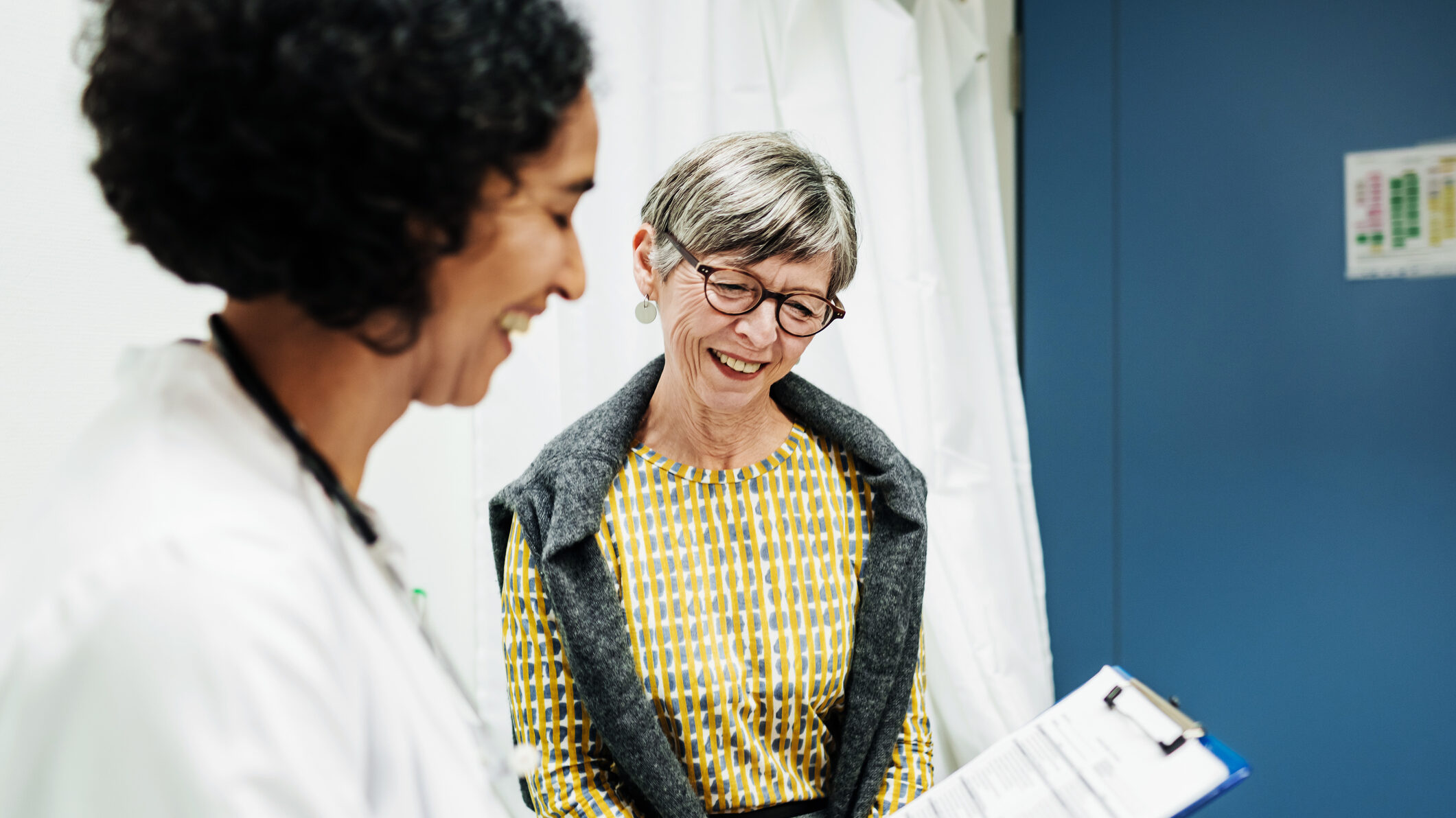 An older woman talking to her GP about her medical history.