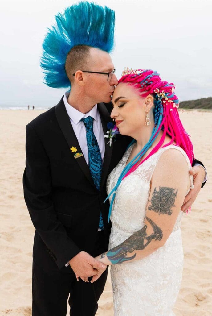 Ryan's wedding day. The bride and groom are sporting colourful hairstyles.